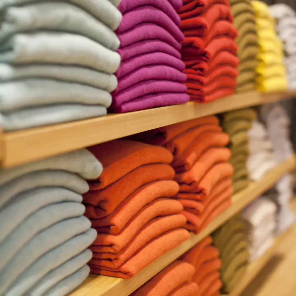 Stacks of clothes at a fast fashion retailer.